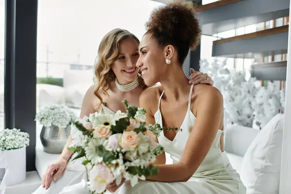 Two brides share a tender moment during their wedding ceremony. — Stock Photo