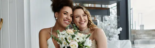 Two brides, one holding a bouquet, smile radiantly on their wedding day. — Stock Photo