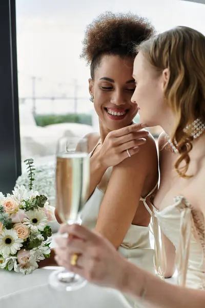 A loving lesbian couple shares a tender moment at their wedding reception. — Stock Photo