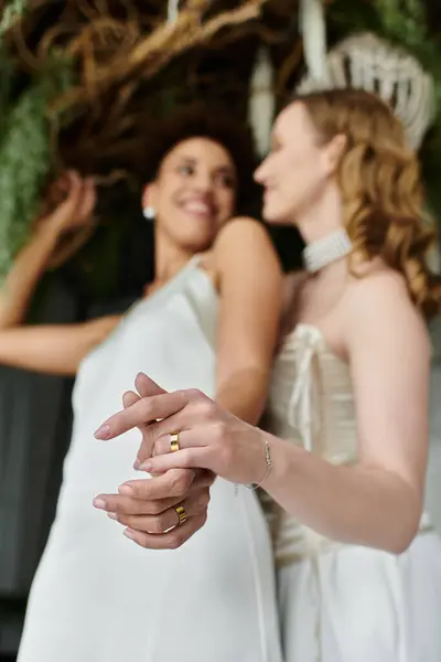 Two brides exchange rings during their wedding ceremony. — Stock Photo