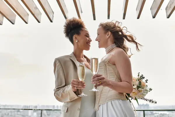 A loving lesbian couple toasts each other on their wedding day. — Stock Photo