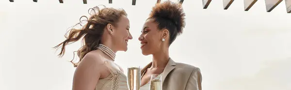 A loving lesbian couple celebrates their wedding day with a toast. — Stock Photo