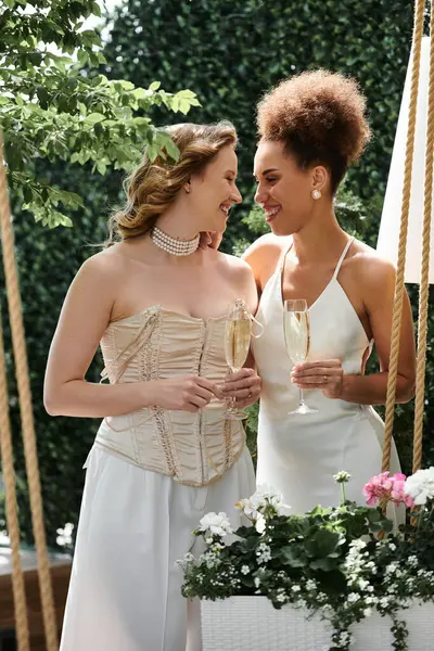 A happy lesbian couple toasts each other on their wedding day. — Stock Photo