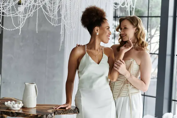 Two brides lovingly gaze at each other on their wedding day. — Stock Photo