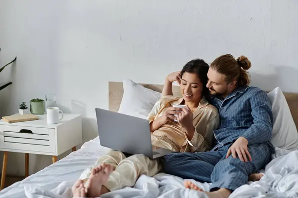 Casal relaxa na cama com café, navegar na internet. — Fotografia de Stock