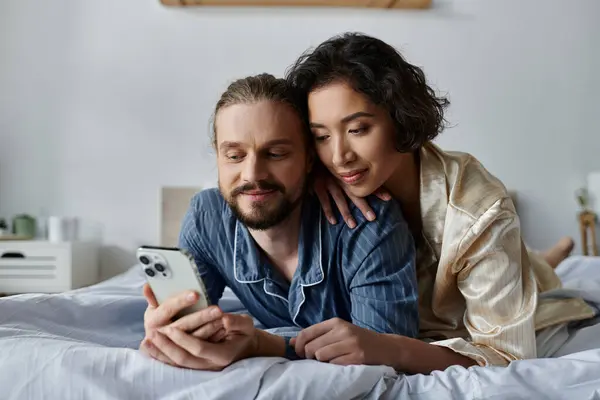 A loving couple relaxes in bed, enjoying each others company. — Stock Photo