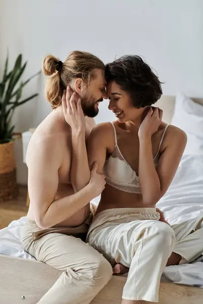 Couple shares intimate moment in bed, faces close whispering sweet nothings. — Stock Photo