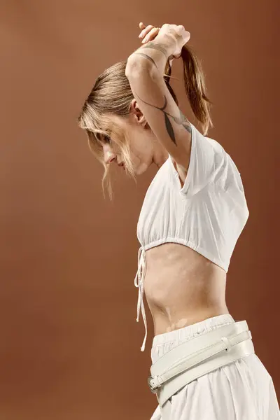 A young woman with vitiligo poses in a white summer outfit against a beige background. — Stock Photo