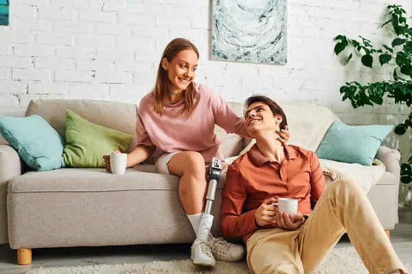 A couple relaxing at home on a couch, sharing a moment of intimacy. — Stock Photo
