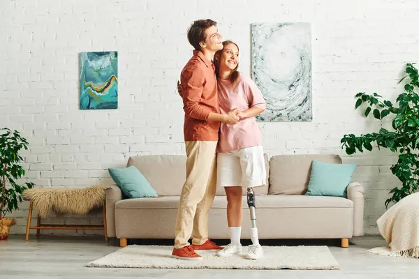 A couple embraces in a contemporary living room setting. — Stock Photo