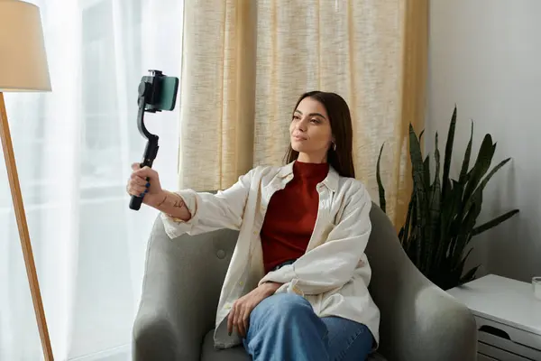 Pretty influencer with tattoos creating video content at home — Stock Photo