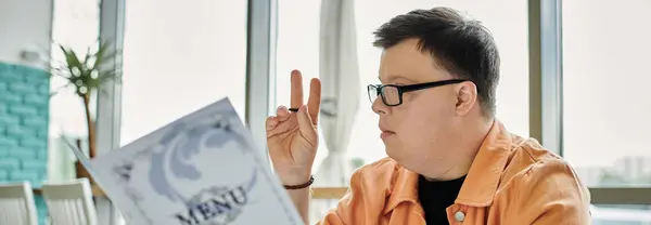 A man with Down syndrome carefully considers his meal options, highlighting the importance of inclusion and diversity in everyday life. — Stock Photo