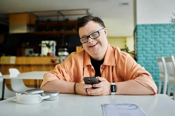 A man with Down Syndrome smiles as he looks at the menu, choosing his meal in a cafe setting. — Stock Photo
