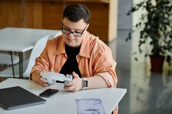 A man with Down syndrome sits in a cafe, working remotely — Stock Photo