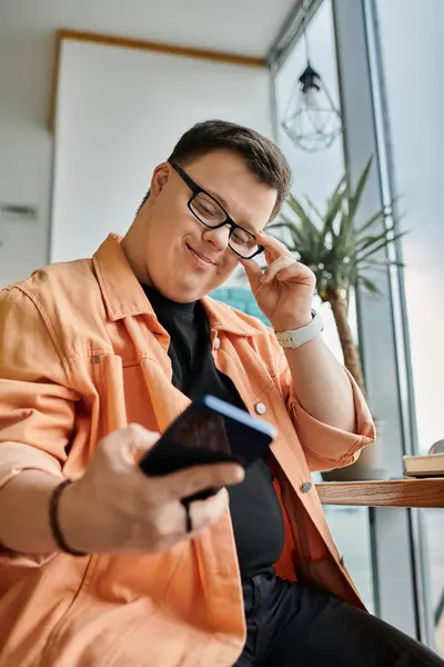 A man with Down syndrome sits in a cafe, working on his laptop, enjoying the freedom of remote work. — Stock Photo
