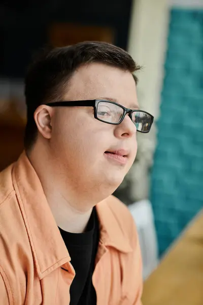 A man with Down syndrome in glasses looking away — Stock Photo
