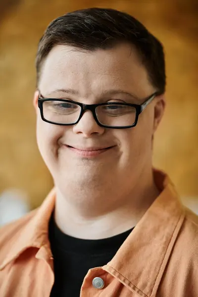 A young man with Down syndrome smiles at camera — Stock Photo