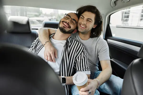 A gay couple shares a tender moment in a car, laughing and holding each other close. — Stock Photo