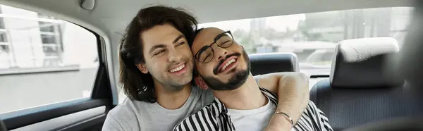 Two men, smiling and happy, hug in the backseat of a car. — Stock Photo