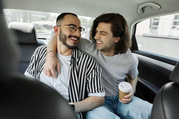 A gay couple shares a tender moment in the backseat of a car. — Stock Photo
