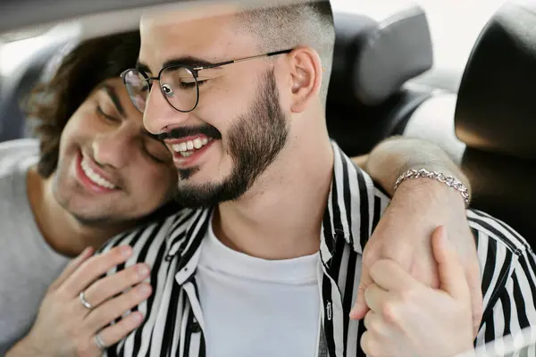Two men sitting in a car, smiling and holding hands. — Stock Photo