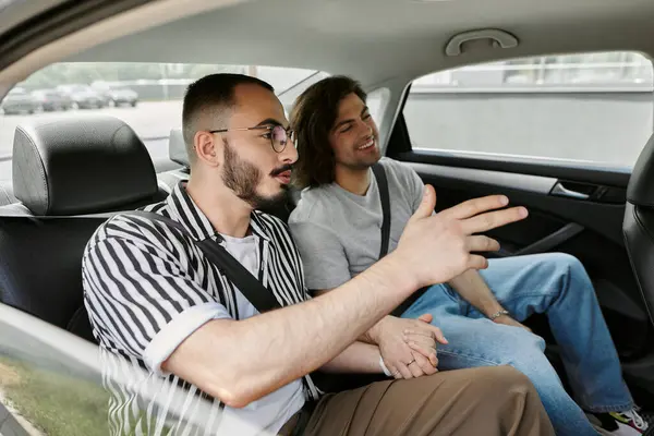 Two men, a gay couple, share a lighthearted moment together in a car. — Stock Photo