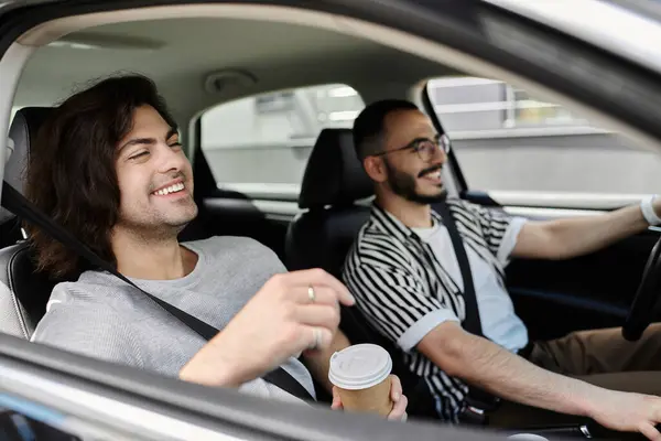 A couple enjoys a sunny afternoon drive, sharing coffee and smiles. — Stock Photo