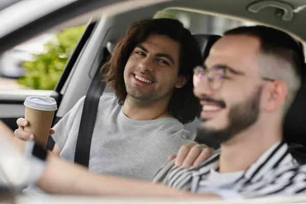 A loving gay couple enjoys a car ride together. — Stock Photo