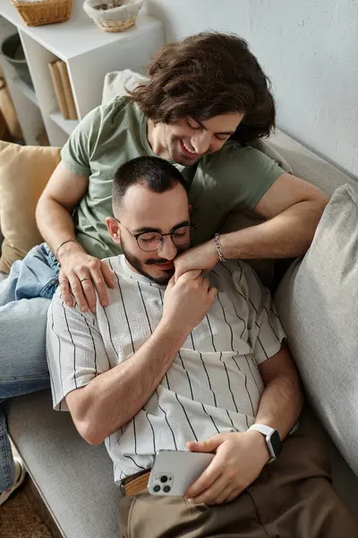 A gay couple shares a tender moment, one man affectionately caressing the other's hand. — Stock Photo