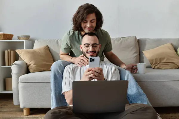 Un couple gay affectueux passe du temps ensemble sur un canapé. — Photo de stock