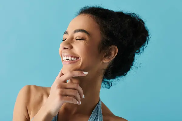 A beautiful young woman with a radiant smile, her eyes closed in pure joy. — Stock Photo