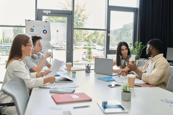 A diverse group of coworkers work on a startup project together. — Stock Photo