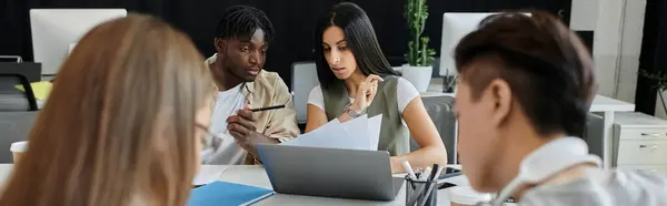 A diverse team of entrepreneurs brainstorm ideas in a modern workspace. — Stock Photo