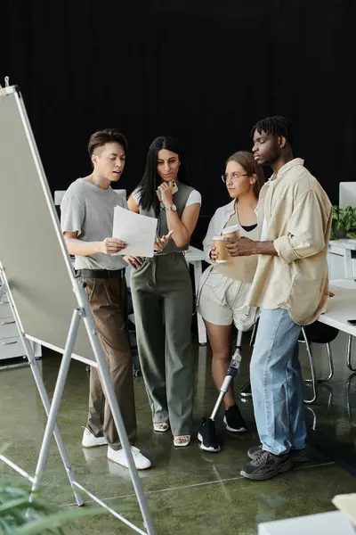 Young professionals discuss startup ideas and strategies around a whiteboard — Stock Photo