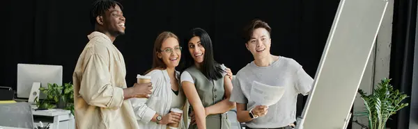A group of young professionals work together in a bright office space. — Stock Photo