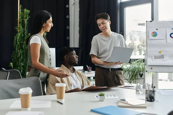 Three coworkers brainstorm ideas around a conference table. — Stock Photo