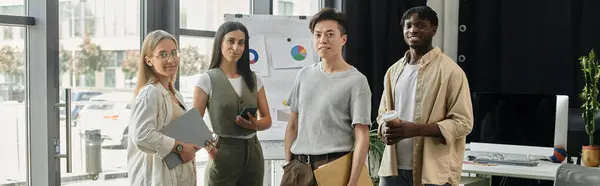 Four young professionals discuss ideas and projects in a contemporary office setting. — Stock Photo
