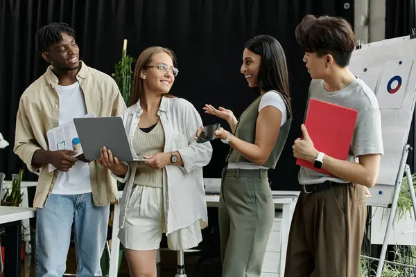 Four colleagues brainstorm in an office space, sharing ideas and collaborating. — Stock Photo