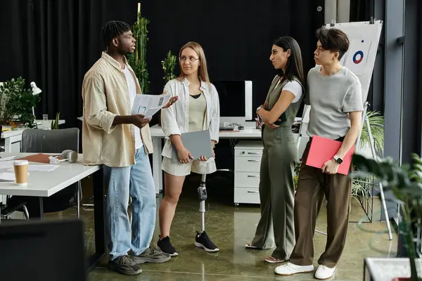 Four young pros brainstorm and discuss new project at table — Stock Photo