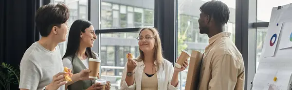Four colleagues relax during their workday, enjoying coffee and conversation. — Stock Photo