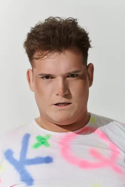 A queer person poses for a close up portrait. — Stock Photo