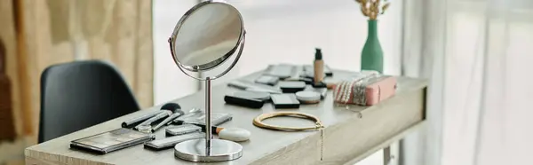 A vanity table is set with makeup, brushes, and a large round mirror. — Stock Photo