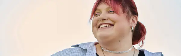 A woman with bright red hair smiles radiantly, enjoying a moment of peace at home. — Stock Photo