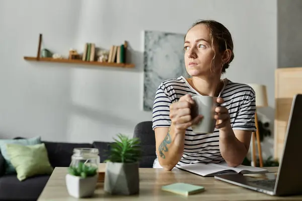 A beautiful woman with vitiligo sips tea while thoughtfully gazing out the window. — Stock Photo