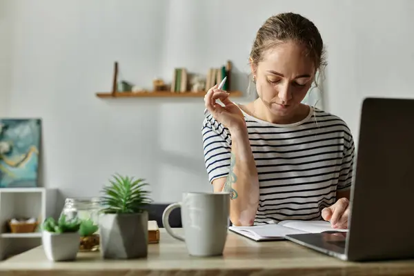 A thoughtful woman with vitiligo writes while surrounded by plants and a warm ambiance. — Stock Photo