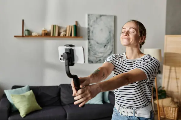 A young woman with vitiligo smiles brightly while taking a selfie indoors. — Stock Photo