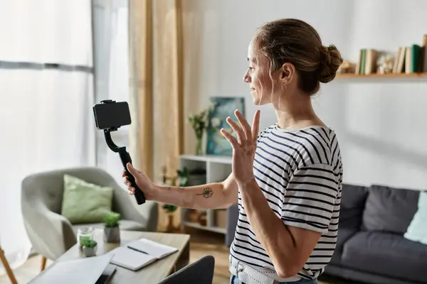 Woman capturing moments with her camera in a bright, inviting space. — Stock Photo