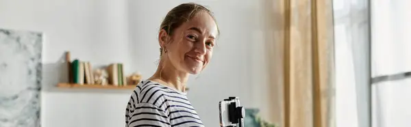 A joyful woman with vitiligo beams while capturing her charming surroundings. — Stock Photo