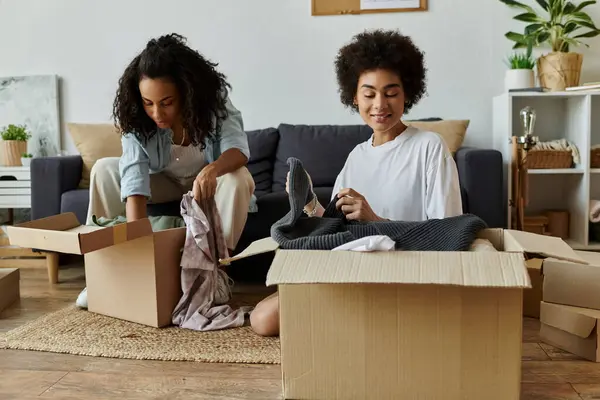 Couple joyfully revamping their wardrobe with creative upcycling projects. — Stock Photo