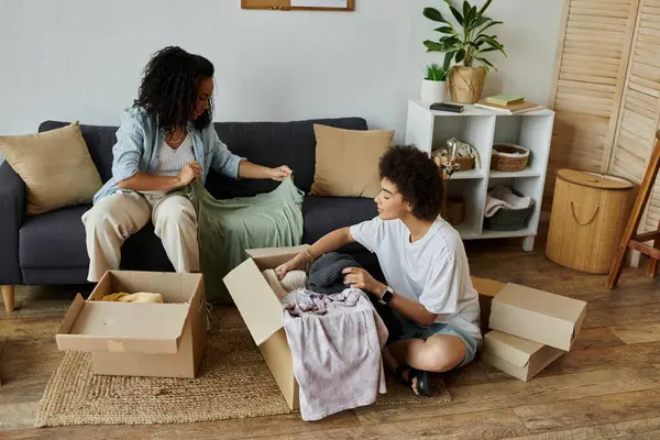 Couple joyfully upcycling clothes together in their stylish home. — Stock Photo